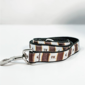 durable fabric pet leash with metal clip. fabric is brown and white alternating, with UW and bucking horse logo printed in brown printed repeatedly on leash fabric