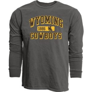 charcoal long sleeved tee. Word Wyoming Cowboys printed on front in brown with thick gold outline. small rectangle with1886 and bucking horse printed in the center of words