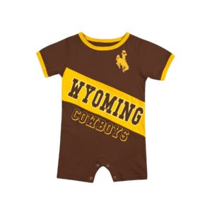 brown infant romper with diagonal design on front. design is rectangle with word Wyoming cut out in gold, with word Cowboys below outlined in gold. gold trim on sleeves and collar