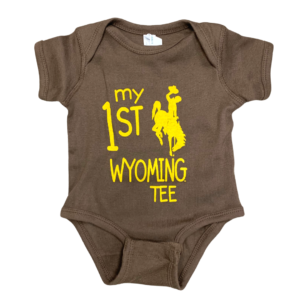 brown infant, short sleeved onesie. Slogan, My 1st Wyoming Tee and a bucking horse printed on front in gold