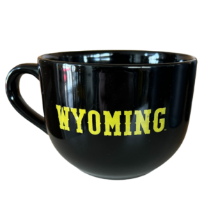 black mug with word Wyoming printed on one side in gold