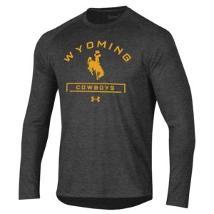 Under Armour brand dark grey, long sleeved tee. Words Wyoming Cowboys arced on the front with bucking horse in center, all printed in gold