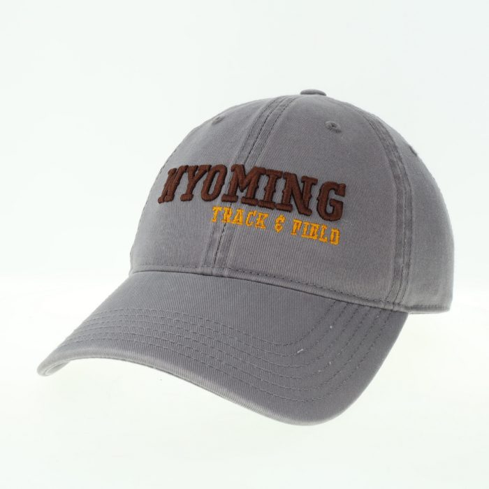 dark grey garment washed, adjustable hat. Word Wyoming embroidered in brown on front, with slogan track and field embroidered in gold below