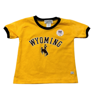 gold, infant short sleeved tee. brown trim on neck and sleeves. Word Wyoming arced with bucking horse below printed in brown on front center of tee