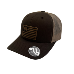 structured, mid profile hat with snapback closure. brown front, khaki mesh back. Leather Wyoming Flag patch with buffalo on front of hat