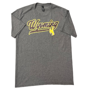 grey, men's short sleeved tee. Word Wyoming printed in brown script font with tail, outlined in gold. bucking horse printed below in gold. design on front center