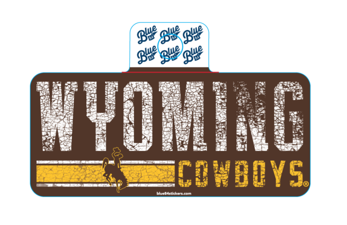brown rectangle decal, design is distressed white word Wyoming above brown bucking horse on gold and white stripes next to distressed gold word cowboys