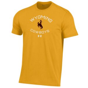Under Armour brand, gold men's short sleeved tee. Slogan Wyoming Cowboys printed in white with black bucking horse in between on front of tee