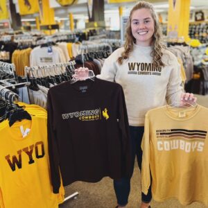 girl holding new wyoming gear