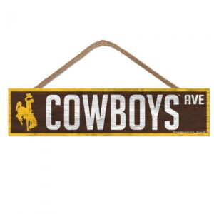 wooden, rectangular sign with rope hanger. brown background, with slogan Cowboys Ave printed in white with gold bucking horse on right side of slogan