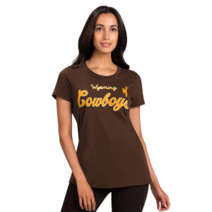 woman wearing brown short sleeve tee, design is word Wyoming in gold script above large word cowboys in gold script, gold bucking horse on left chest