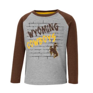 long sleeved toddler tee. Grey body with brown sleeves. Design on front is outline bricks, with slogan Wyoming Cowboys and bucking horse printed diagonally in brown and gold