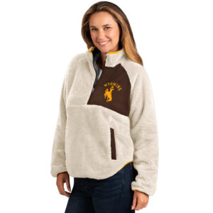 woman wearing white sherpa half zip jacket, half of chest is brown, design is gold word Wyoming arched over gold bucking horse