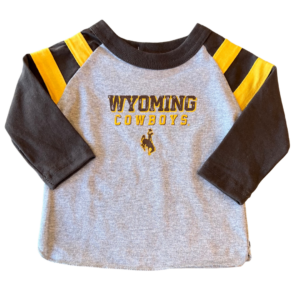 grey infant long-sleeved tee, with brown sleeves. Slogan Wyoming Cowboys and bucking horse printed on front of tee. two gold stripes on the top of each sleeve