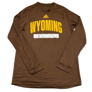 Adidas brown long sleeve athletic shirt, design is gold Adidas log above large gold word Wyoming in arch, white bar with light grey design below