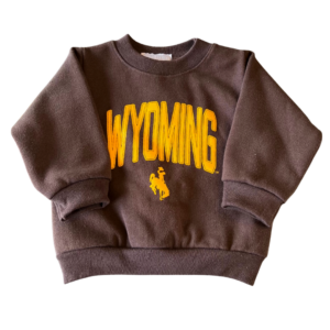 infant brown crew neck sweatshirt, design is word Wyoming in gold arched over gold bucking horse
