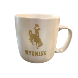 pearl white bistro mug, design is gold bucking horse above gold word Wyoming, handle on right