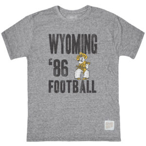 grey short sleeve shirt, design is words Wyoming '86 Football stacked on right of shirt, gold and white pistol pete on left of shirt