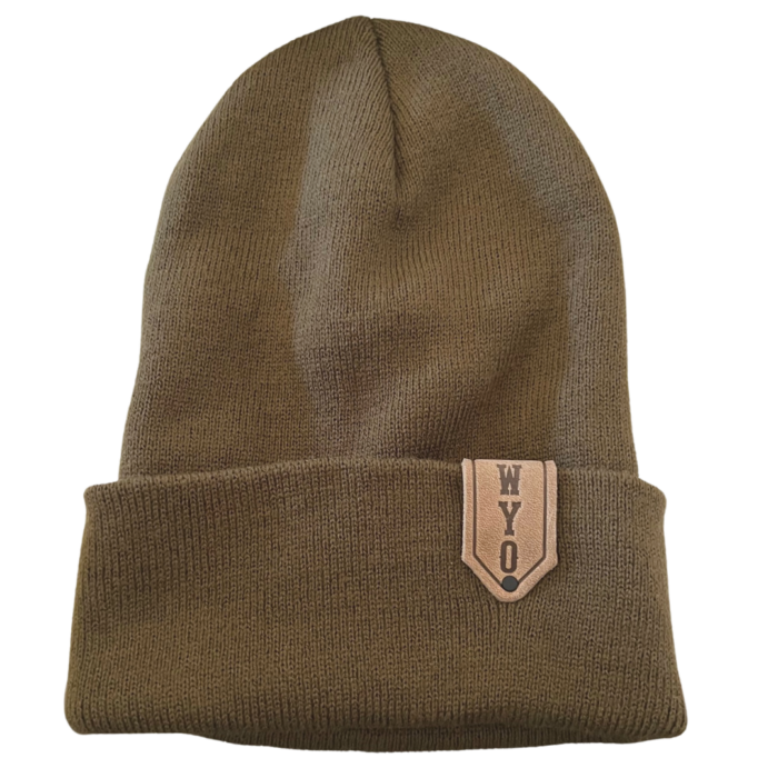 olive colored rib knit beanie with fold up cuff. small, brown leather patch on left side of cuff, with slogan WYO embossed vertically