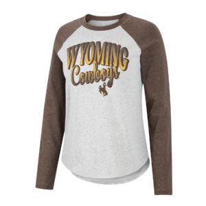 women's brown long sleeve baseball tee with grey body, design is word Wyoming in brown fading to gold above script word cowboys in brown fading to gold above brown bucking horse