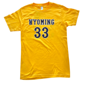 gold short sleeve tee. design is word Wyoming in brown outlined in white with number 33 below in brown outlined in white