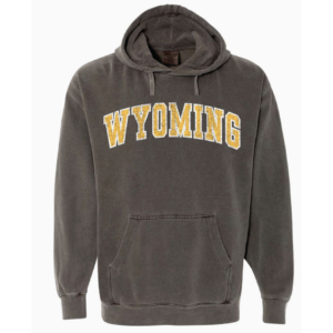 grey hooded sweatshirt, distressed color and design, design is gold word Wyoming outlined in white