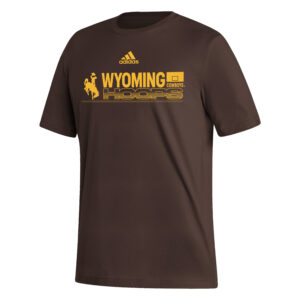 Adidas brown short sleeve tee, design is gold Adidas logo above word gold word Wyoming above gold outlined word hoops, gold bucking horse on left, gold basketball hoop on right