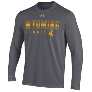 Under Armour men's grey long sleeve tee shirt, design is gold Under Armour logo above gold word Wyoming with stripe through center above word cowboy, gold bucking horse on left