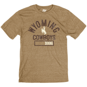 men's russett colored short sleeve tee, design is brown word Wyoming above cream bucking horse above word cowboys above brown rectangle with cream 1886 on right