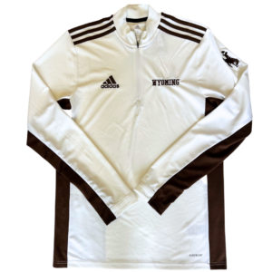 white pull over jacket. Brown accent fabric on shoulders, side seams and bottom of sleeves. Brown Adidas logo embroidered on right chest, word Wyoming embroidered on left chest. Brown bucking horse on left sleeve