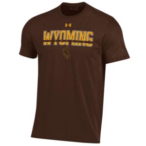 Under Armour brown tee, design is gold Under Armour logo above gold word Wyoming white outline behind gold word cowboys in brown bar above bucking horse