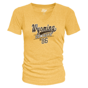 Light gold women's tee, design is brown script word Wyoming with tail white outline, above white word cowboys between brown lines, above brown small 18 large 86