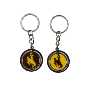 Metal spinner keychain, design is brown circle gold bucking horse on one side and gold circle brown bucking horse on the other side