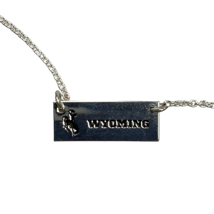 Silver bar necklace, design is black bucking horse then black word Wyoming
