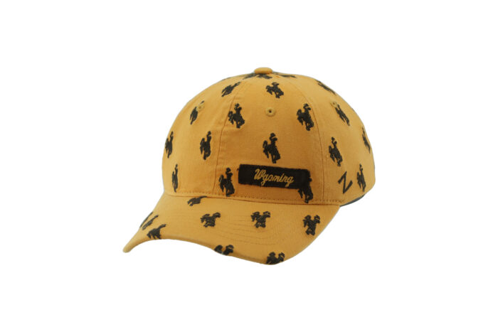 Women's gold adjustable hat, design is repeating brown bucking horse design with brown stripe on left side of hat, gold script word Wyoming in stripe