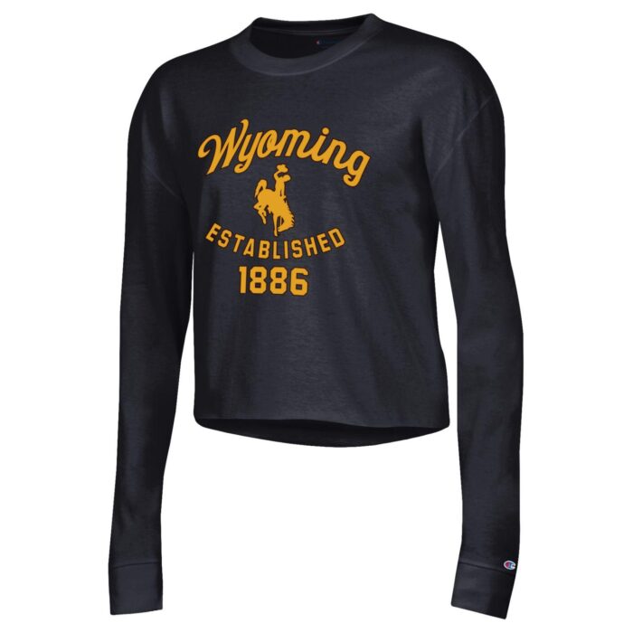 Women's black cropped long sleeve, design is gold script word Wyoming above gold bucking horse, gold established 1886 below bucking horse