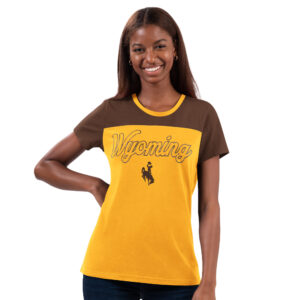 women's short sleeved tee. main body is gold, with shoulders and neckline brown. Word Wyoming printed on front in glitter outline font, brown bucking horse below