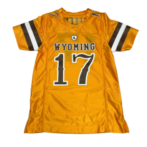 gold youth sized football jersey. Word Wyoming and number 17 on front in brown with white outline