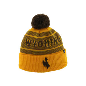 Gold beanie with brown stripes, design is brown word Wyoming above brown bucking horse on cuff, brown pom detail on top