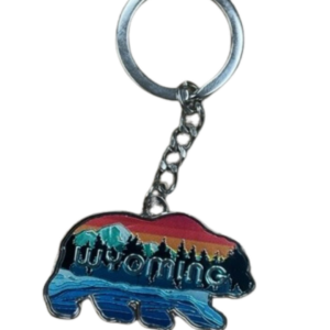 Bear shaped keychain, design is word Wyoming in front of nature scene