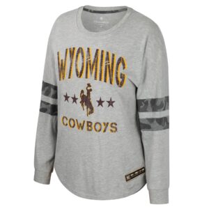 Women's grey long sleeve, design is brown word Wyoming gold shadow, above brown bucking horse gold outline with brown stars on sides, above brown word cowboys gold shadow