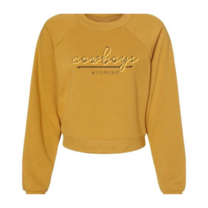 Women's gold cropped crew, design is brown script word cowboys white outline above brown line above brown word Wyoming