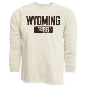 Women's oatmeal long sleeve, design is brown word Wyoming above brown box with oatmeal colored word 1886