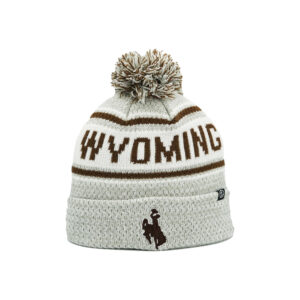 White beanie with brown and white pom on top, design is brown word Wyoming surrounded by lines above brown bucking horse