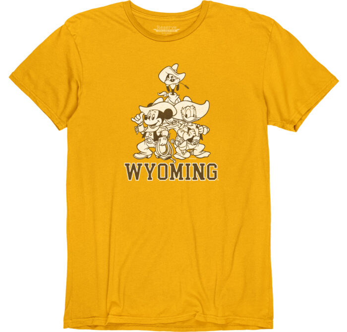 Gold short sleeve t-shirt with a picture of three disney characters. Goofy is pictured on the top, mickey mouse below to the left and donald duck on the right of mickey mouse. Underneath the picture is the word Wyoming in Brown outlined in white.