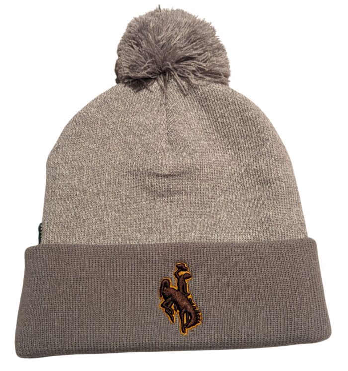 Grey Beanie with cuff on bottom and pom on top. On cuff, brown bucking horse with yellow outline.