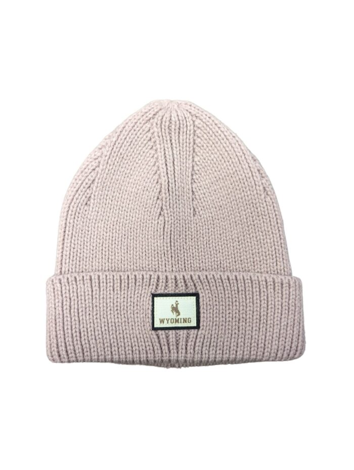 knit light pink beanie. cuffed on bottom with square patch, bucking horse and Wyoming in patch.