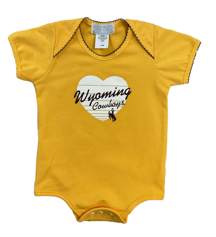 gold onesie with decorative stitching around shoulder and neck. design on front, white heart with Wyoming cowboys in brown script. bucking horse under cowboys