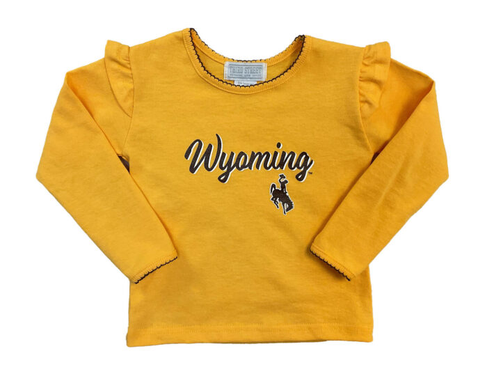 gold kids long sleeve tee with decorative stitching around neck and wrists, with ruffles on shoulder. Wyoming in brown script with white outline and bucking horse under Wyoming