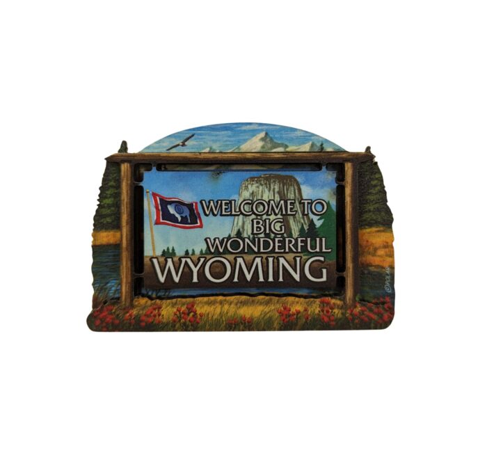 2 x 1.5 magnet with design. Design is image of Devils Tower Mountain scape in background with welcome to big wonderful Wyoming in white with state flag to the left.